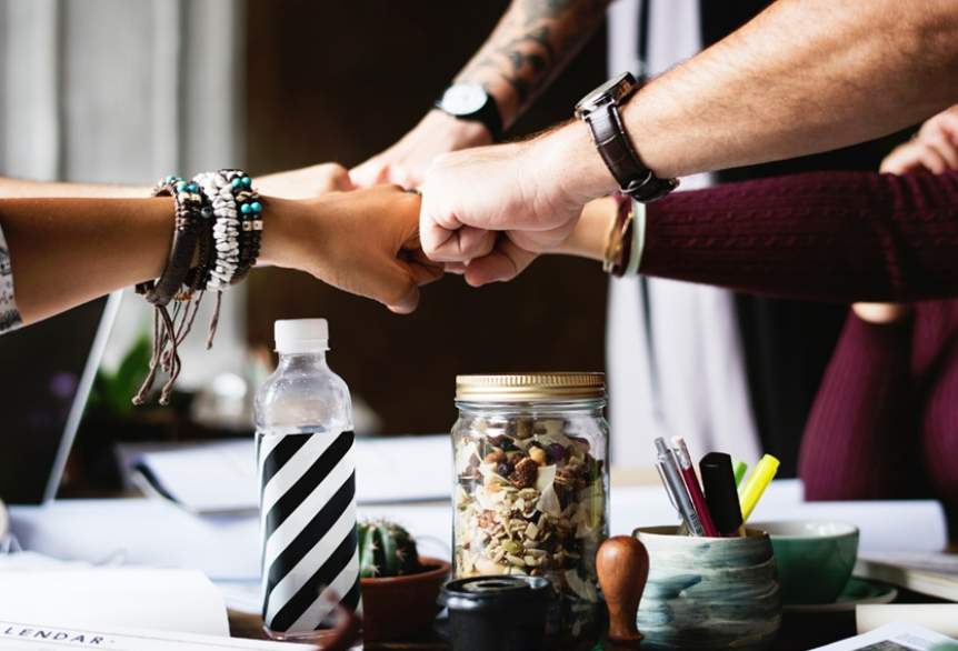 Fist bumping after the end of studying