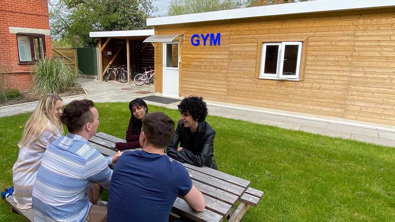 Students at Leicester studios chilling outside by gym